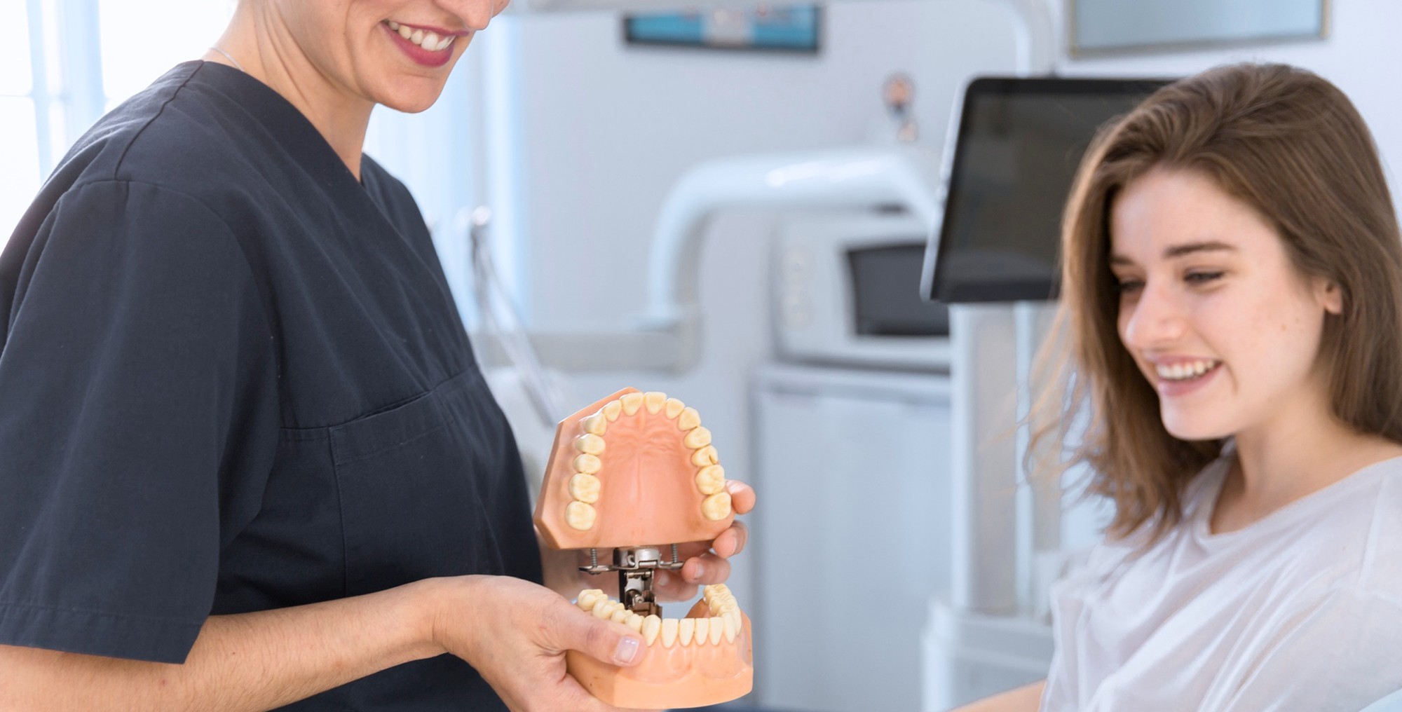 doctor talking to patient sitting in a dental chair