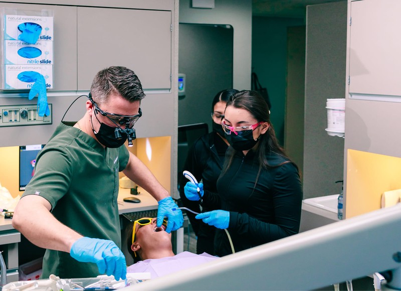 a dentist with a patient in a dental office