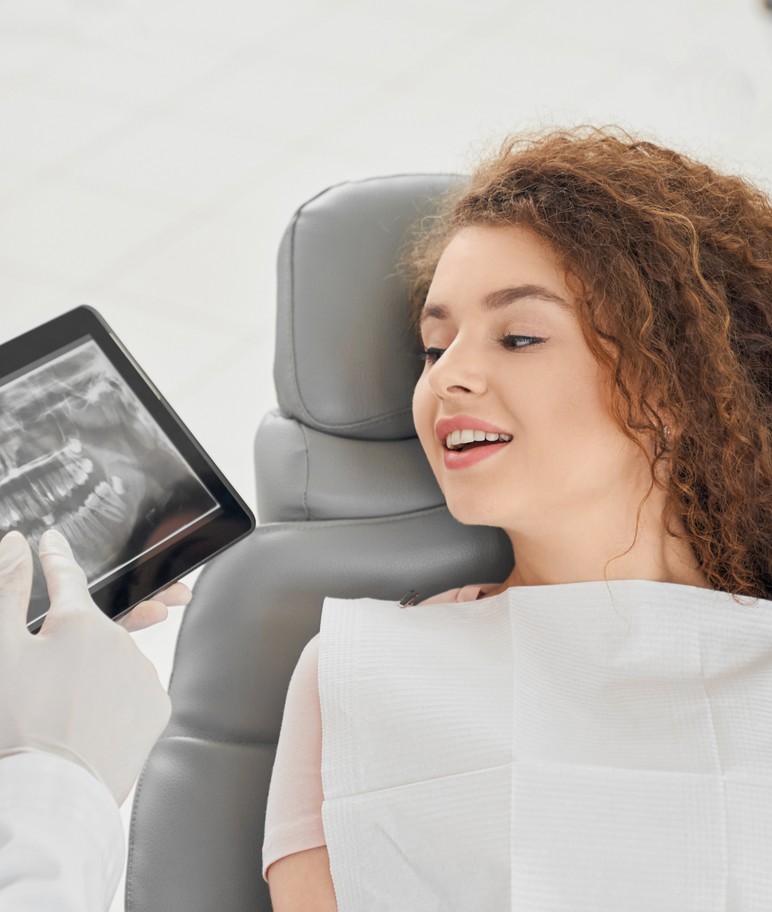 Dentist and patient looking at x-ray