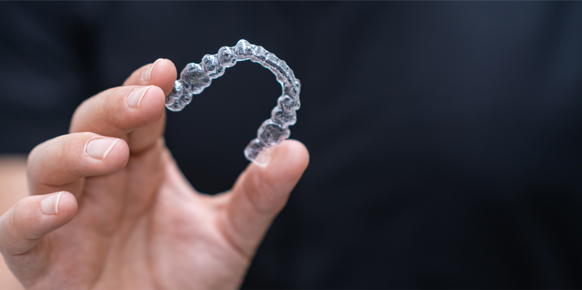 person holding invisalign