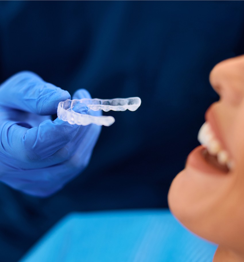 doctor giving invisalign to a female patient